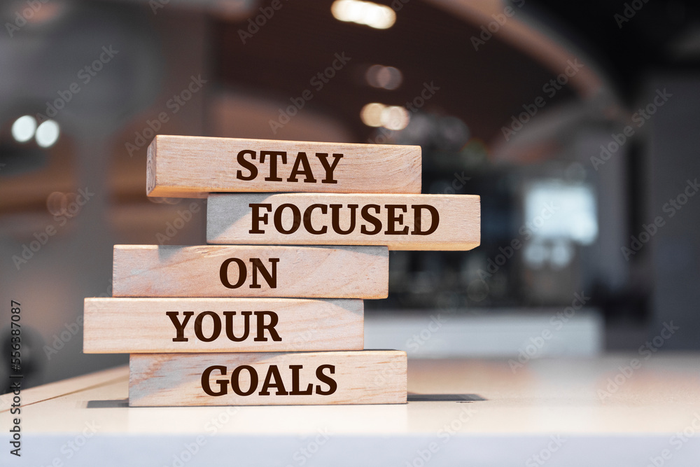 Wooden blocks with words 'Stay focused on your goals'.