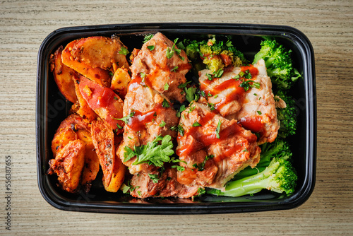 Delicious BBQ chicken with broccoli and red potatoes in a to-go container