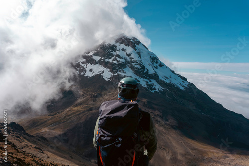 a mountaineer reaches the top of a mountain