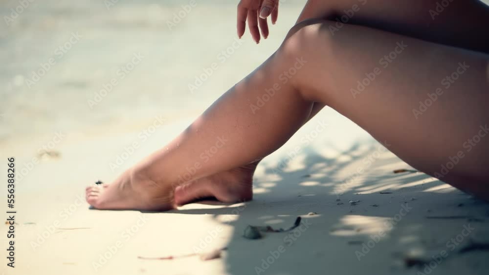 slender tanned female legs relaxing in shade slender tanned female legs relaxing in shade