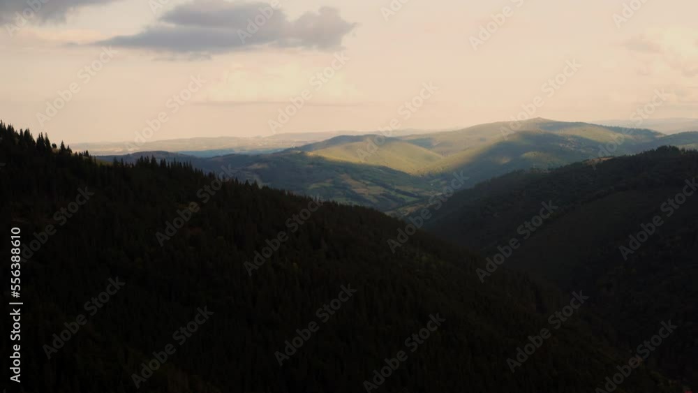 Dramatic view of sunlight illuminating mountain peak during sunrise. Predeal, Romania. Aerial. Dramatic view of sunlight illuminating mountain peak during sunrise. Predeal, Romania. Aerial.