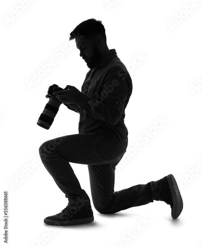 Silhouette of male photographer with camera on white background