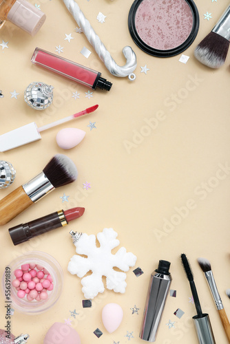 Composition with cosmetics, makeup accessories and Christmas decorations on color background