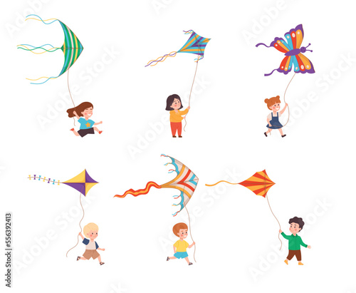 Set of little happy kids playing with colorful kites flat style