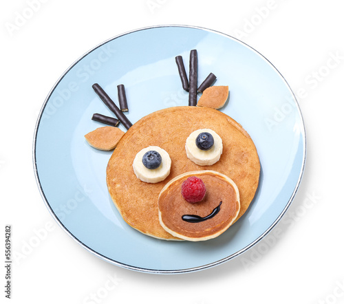 Plate with tasty pancakes in shape of Christmas reindeer on white background