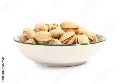 Plate with tasty pistachio nuts isolated on white background