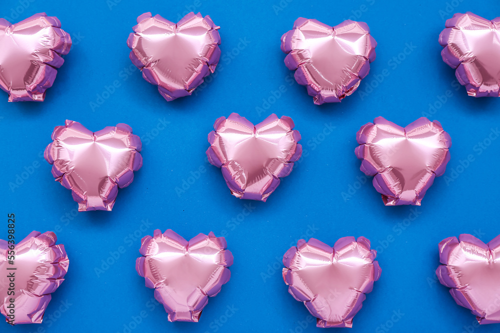 Pink heart-shaped balloons on blue background. Valentine's Day celebration