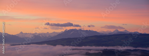 Breathtaking panorama of central Swiss alps with mount Pilatus, Eiger and Jungfrau, early morning in winter with purple and blue sky, Switzerland