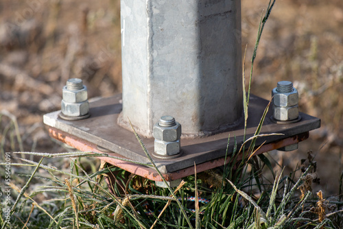 Fastening the electric pole with bolts.