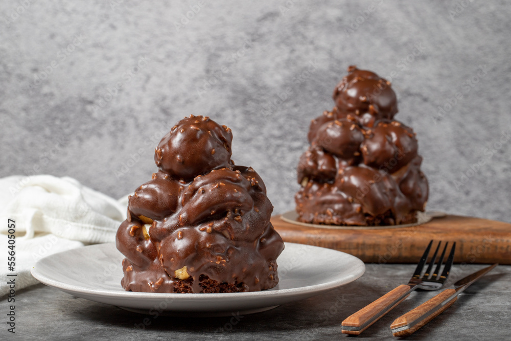 Chocolate cake on a dark background. Dessert with chocolate sprinkled on profiteroles grains. Bakery products Chocolate cake on a dark background. Dessert with chocolate sprinkled on profiteroles grains. Bakery products