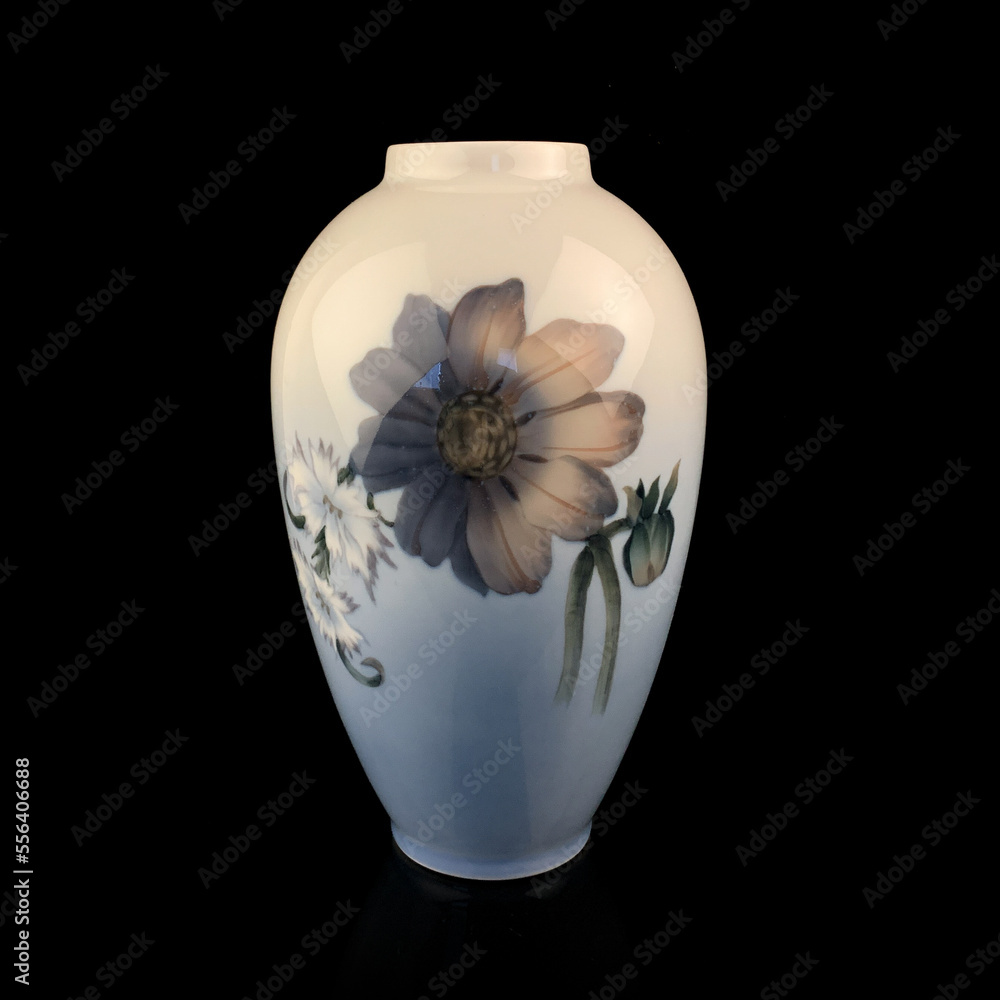 beautiful blue vase with a flower pattern on a black isolated background. antique porcelain vase with painting beautiful blue vase with a flower pattern on a black isolated background. antique porcelain vase with painting