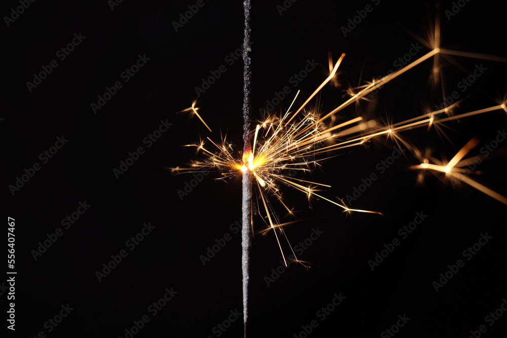 burning sparkler, bengal lights on a black background burning sparkler, bengal lights on a black background