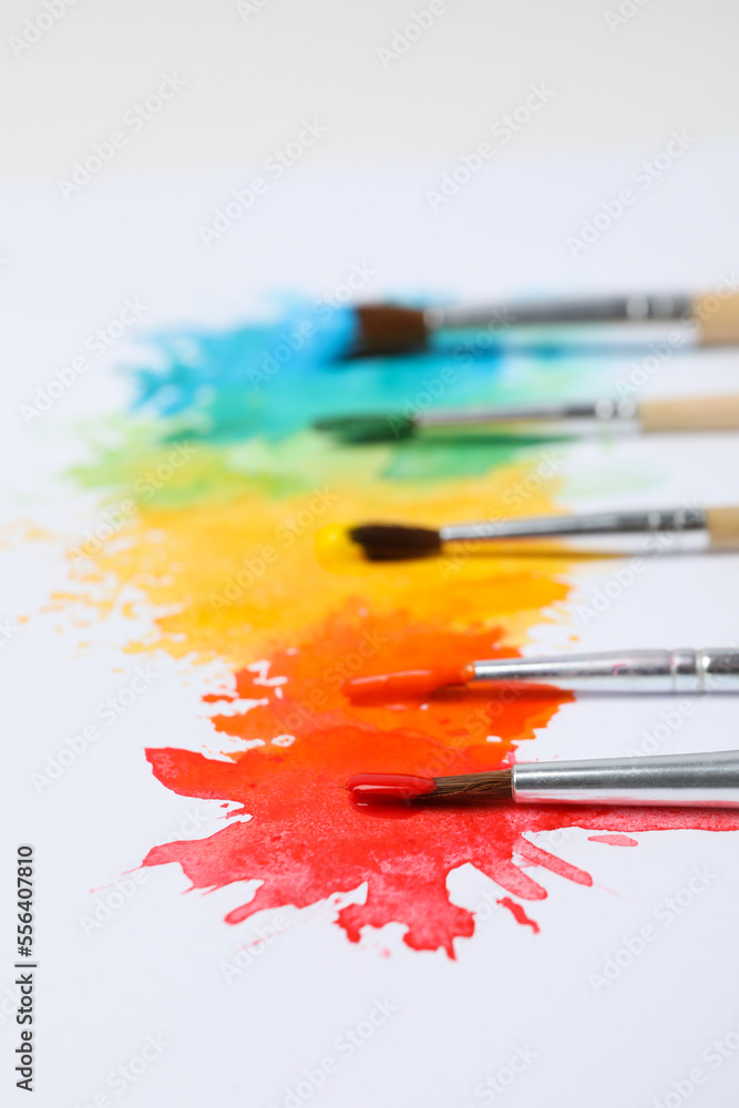 Obraz premium Paint brushes with paints on white background