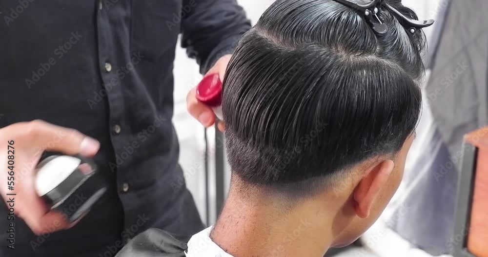 Male client getting haircut by hairdresser. Barber using scissors and comb. Man getting haircut in barber shop. Modern hair salon concept. Male client getting haircut by hairdresser. Barber using scissors and comb. Man getting haircut in barber shop. Modern hair salon concept.