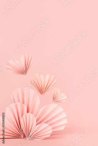 Valentines day scene - pink ribbed paper hearts with flying heart on soft light pink, copy space, vertical. Lovely love mockup for presentation cosmetic product, goods, design, card, poster, flyer. © finepoints