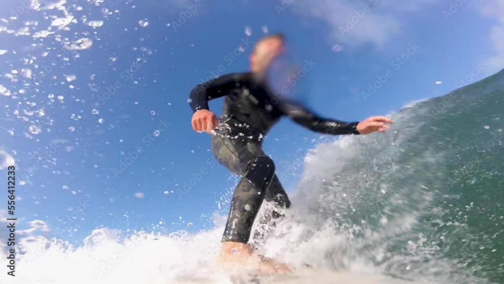 Surfer is jumping above wave while surfing. Slow motion. Water sports concept. Surf surf point. Surfer is jumping above wave while surfing. Slow motion. Water sports concept. Surf surf point.