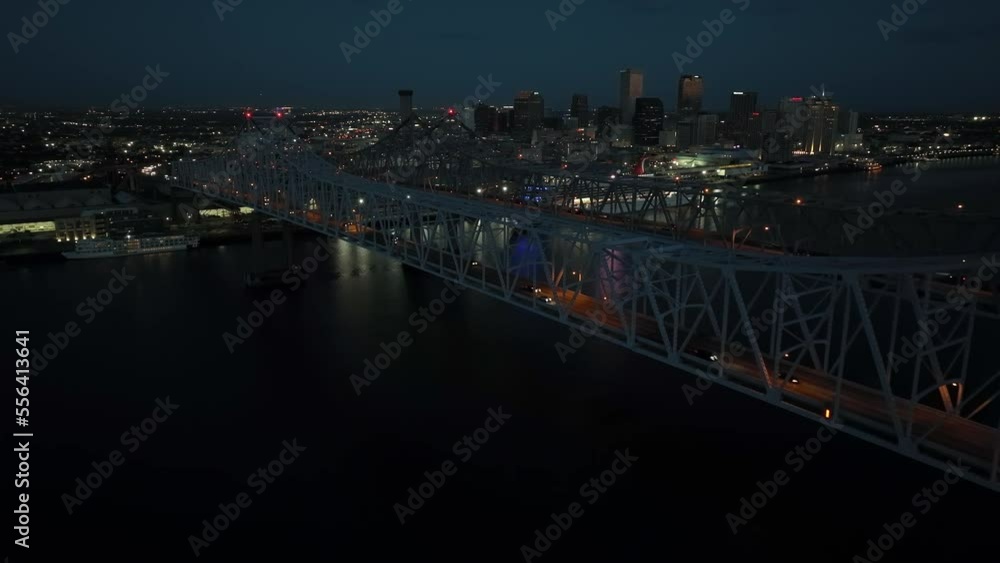 Huey P Long bridge over Mississippi at night with lights. New Orleans skyline cityscape in evening. Aerial view. Huey P Long bridge over Mississippi at night with lights. New Orleans skyline cityscape in evening. Aerial view.