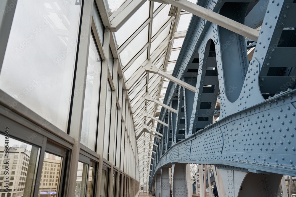 iron and glass structures. riveted metal supports and large windows. a beautiful modern building of a closed pedestrian bridge. iron and glass structures. riveted metal supports and large windows. a beautiful modern building of a closed pedestrian bridge.