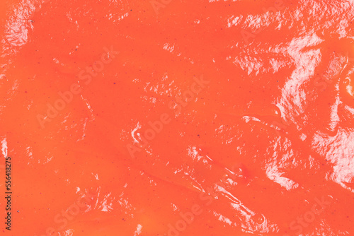 Orange sauce splashes as background.