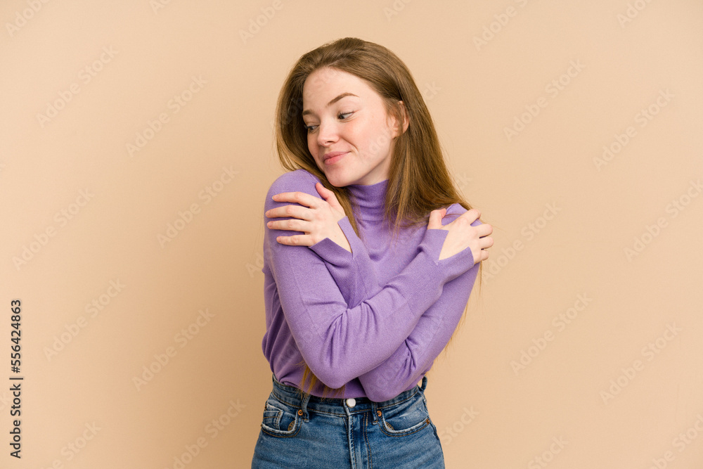 Young redhead woman cut out isolated hugs, smiling carefree and happy. Young redhead woman cut out isolated hugs, smiling carefree and happy.