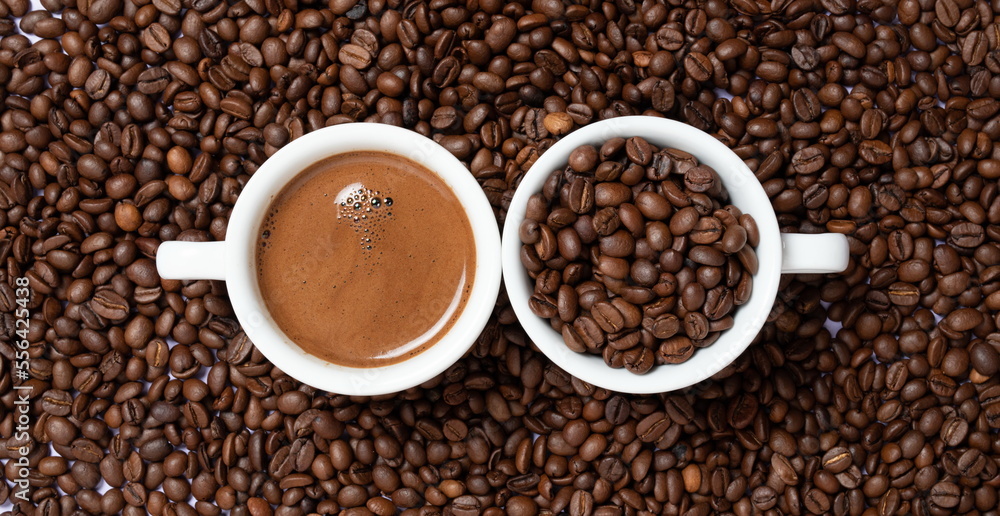 two cups of coffee on coffee beans on a brown background. two cups of coffee on coffee beans on a brown background.