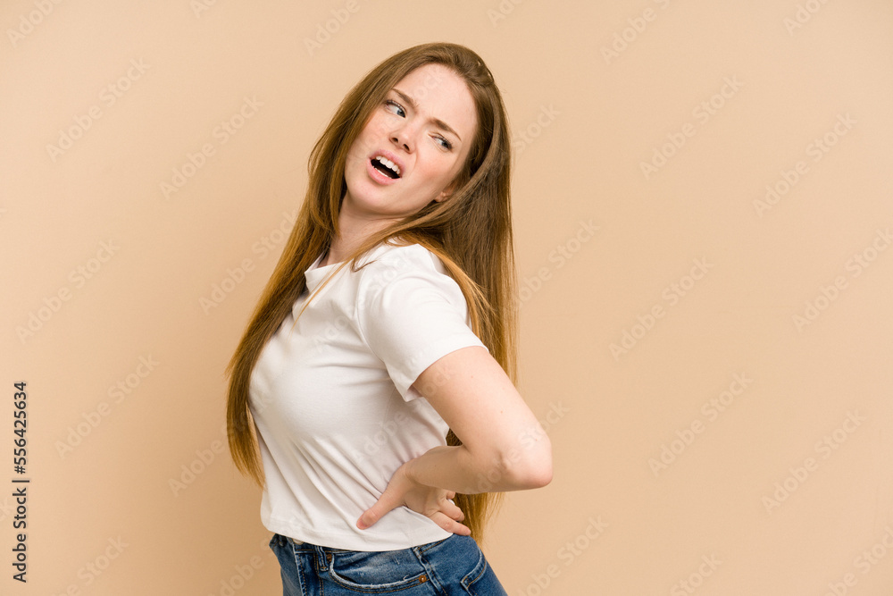 Young redhead woman cut out isolated suffering a back pain. Young redhead woman cut out isolated suffering a back pain.