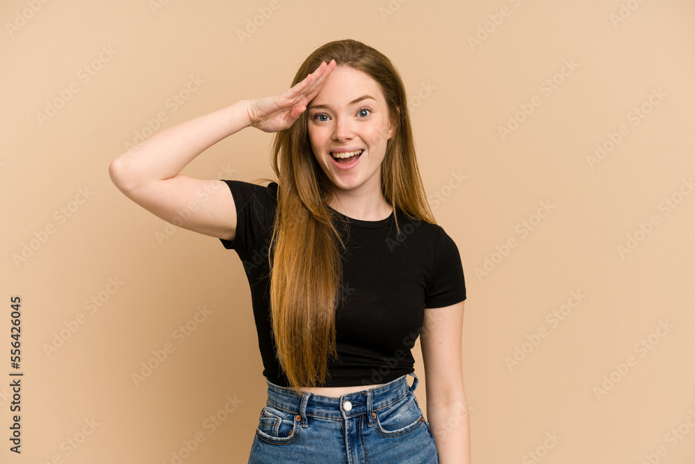 Young redhead woman cut out isolated shouts loud, keeps eyes opened and hands tense. Young redhead woman cut out isolated shouts loud, keeps eyes opened and hands tense.