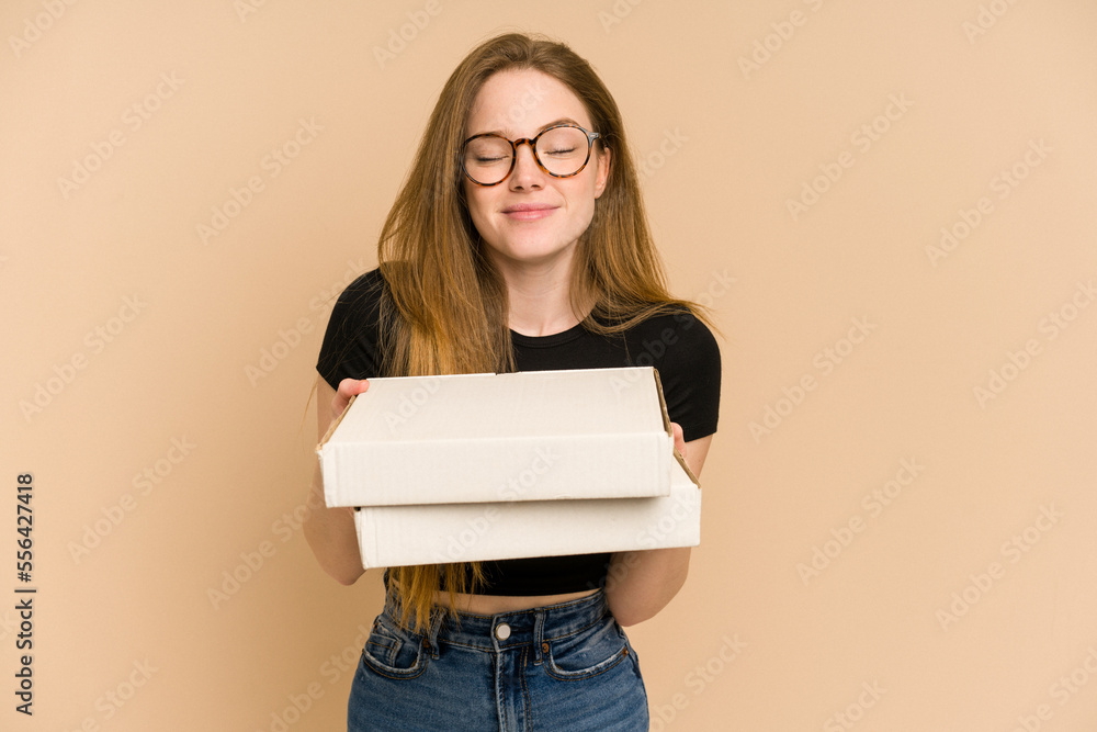 Young redhead woman holding two pizza boxes cut out isolated Young redhead woman holding two pizza boxes cut out isolated