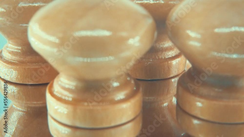 Rotating macro shot of a Round wooden handles on a reflectin plate, slow motion close up, 4K photo