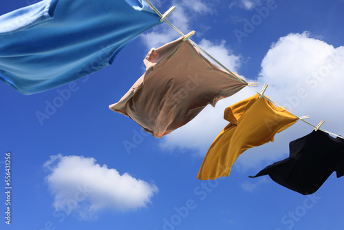 The wind blew clothes that had been dried in the sun and blown under the blue summer sky with cloud  symbolizing the work of housewives.