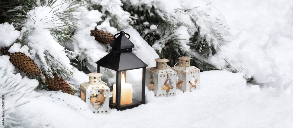 Lanterns in the snow under the Christmas tree Lanterns in the snow under the Christmas tree