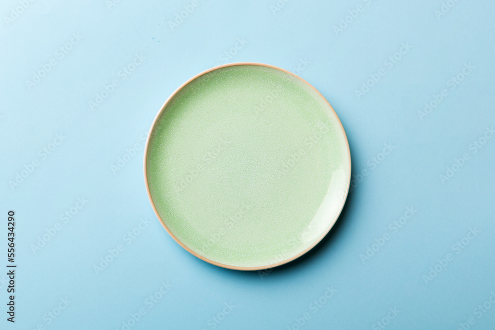Top view of isolated of colored background empty round green plate for food. Empty dish with space for your design Top view of isolated of colored background empty round green plate for food. Empty dish with space for your design