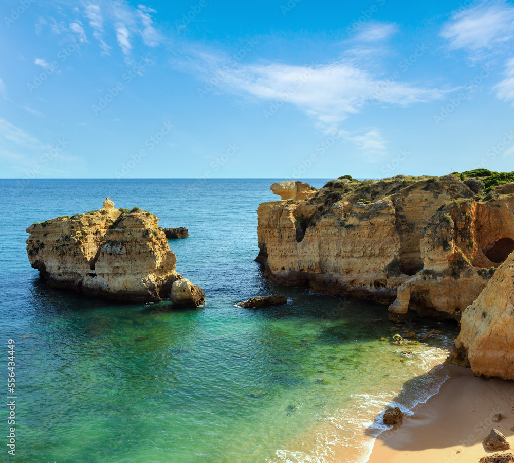 Naklejka premium Summer evening Atlantic rocky coast view and sandy beach Praia de San Rafael with limestone cliffs, Albufeira, Algarve, Portugal).
