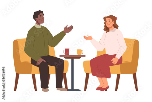 Businessman or celebrity character sitting on chair and giving an interview to female journalist. Press conference, live report, people sitting at table with coffee and talking