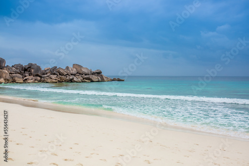 Beautiful nature of the sea tropical landscape. Exotic tropical nature of the Seychelles  a white beach surrounded by palm trees and granite rocks.