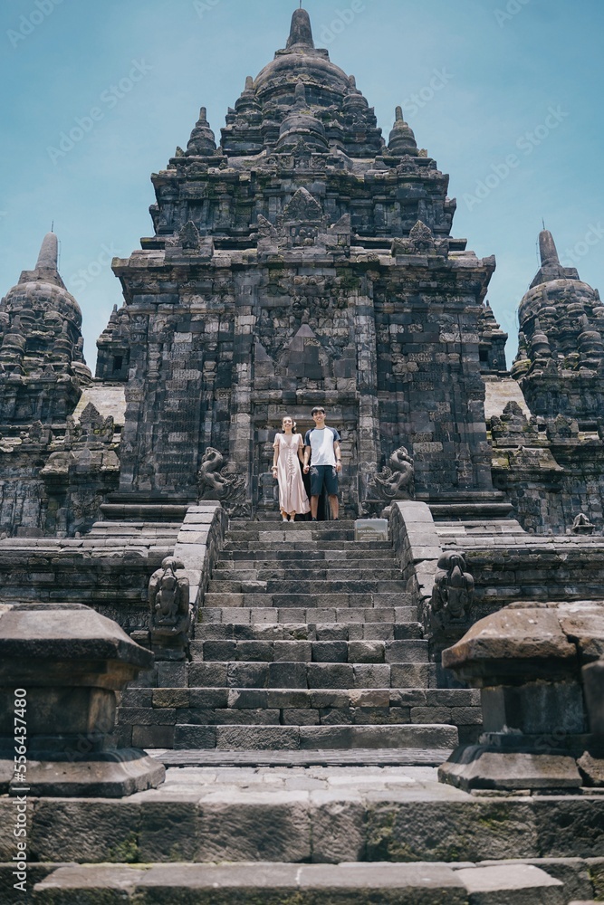 Naklejka premium couple of tourists at prambanan temple, yogyakarta indonesia.