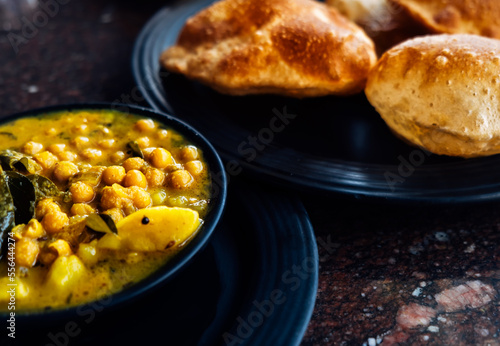 Puri bhaji the national breakfast dish of Indian cuisine. Authentic food in India. Fried puris and beans spicy sauce.