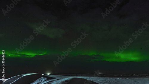 A unique natural atmospheric phenomenon. The Northern lights over the Yamal Peninsula. Polar winter night in the Arctic. Snow-covered landscape of the northern tundra photo