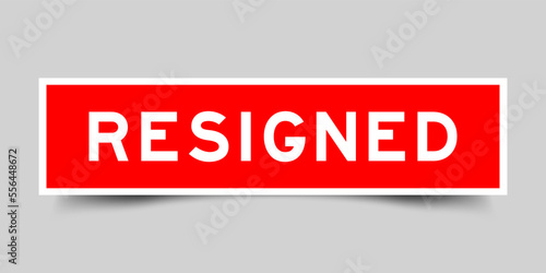 Red color square label sticker with word resigned on gray background
