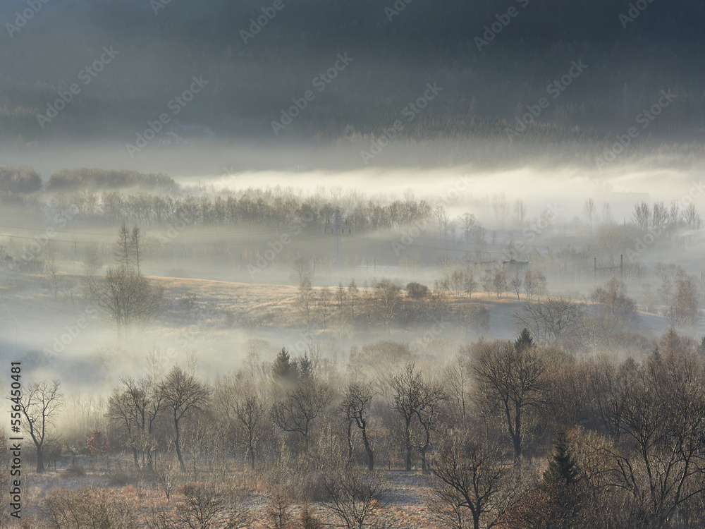 Morning fog in the Central Sudetes. The city of Boguszow-Gorce in the fog. Beautiful landscape of the Stone Mountains at sunrise.