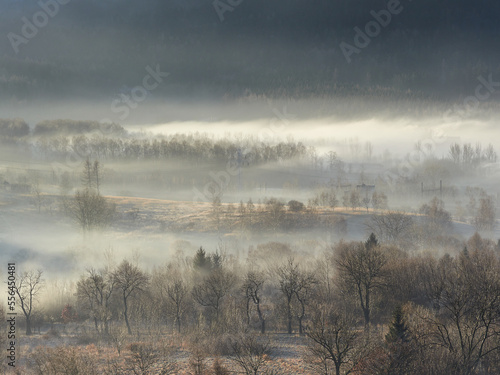 Morning fog in the Central Sudetes. The city of Boguszow-Gorce in the fog. Beautiful landscape of the Stone Mountains at sunrise.