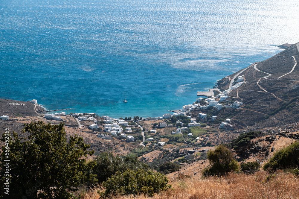 Bay and village of Isternia, Tinos Island with Cycladic houses, crystal clear water of the Aegean Sea on Tinos island, Cyclades, Greece