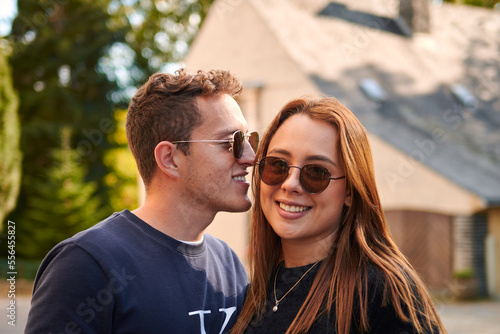 A shallow focus portrait of lovely young Hispanic couple standing in the street