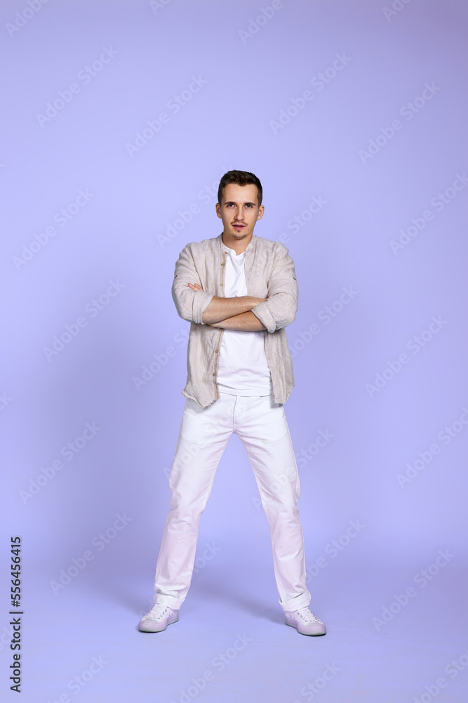 man wearing shirt and white pants holding hands crossed man wearing shirt and white pants holding hands crossed