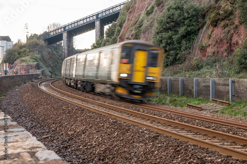 train on railway going fast on slight bend in Dawlish uk blurred motion with train