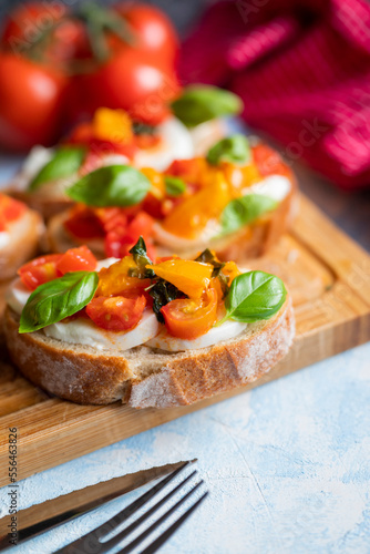 crispy bruschetta bread with mozzarella cheese with tomatoes and basil