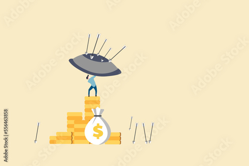 Businessman or banker protecting stacked coins his investments with shield against of arrow. concept of Wealth protection, asset allocation portfolio in market or saving financial and economic crisis.