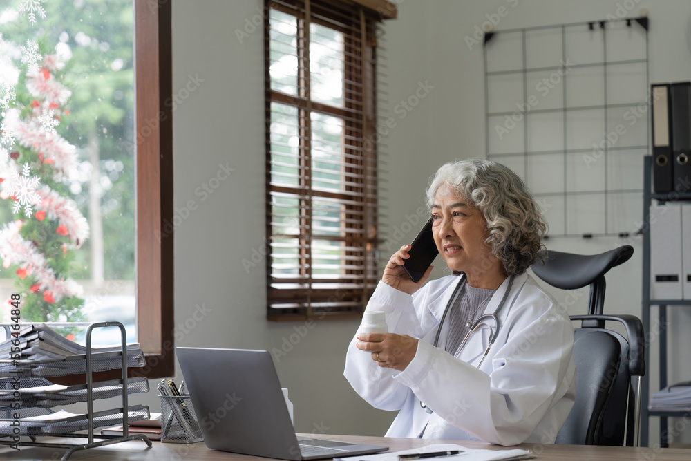 Senior asian female doctor using mobile phone talking while sitting in hospital office. happy woman medical worker having joyful conversation with husband in break time. nurse resting in clinic Senior asian female doctor using mobile phone talking while sitting in hospital office. happy woman medical worker having joyful conversation with husband in break time. nurse resting in clinic