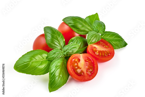 Fresh cherry tomatoes with Sweet basil leaves, isolated on white background.