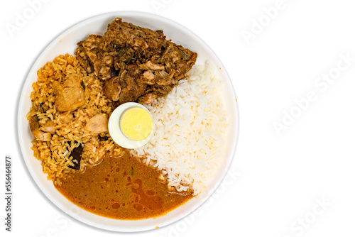Homemade healthy non veg lunch combo meal with chicken briyani, white rice, mutton roast or curry or masala, chicken gravy or kozhambu with boiled egg.